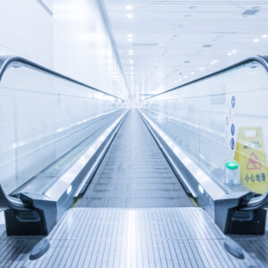 Blank billboard and modern escalator at a international airport